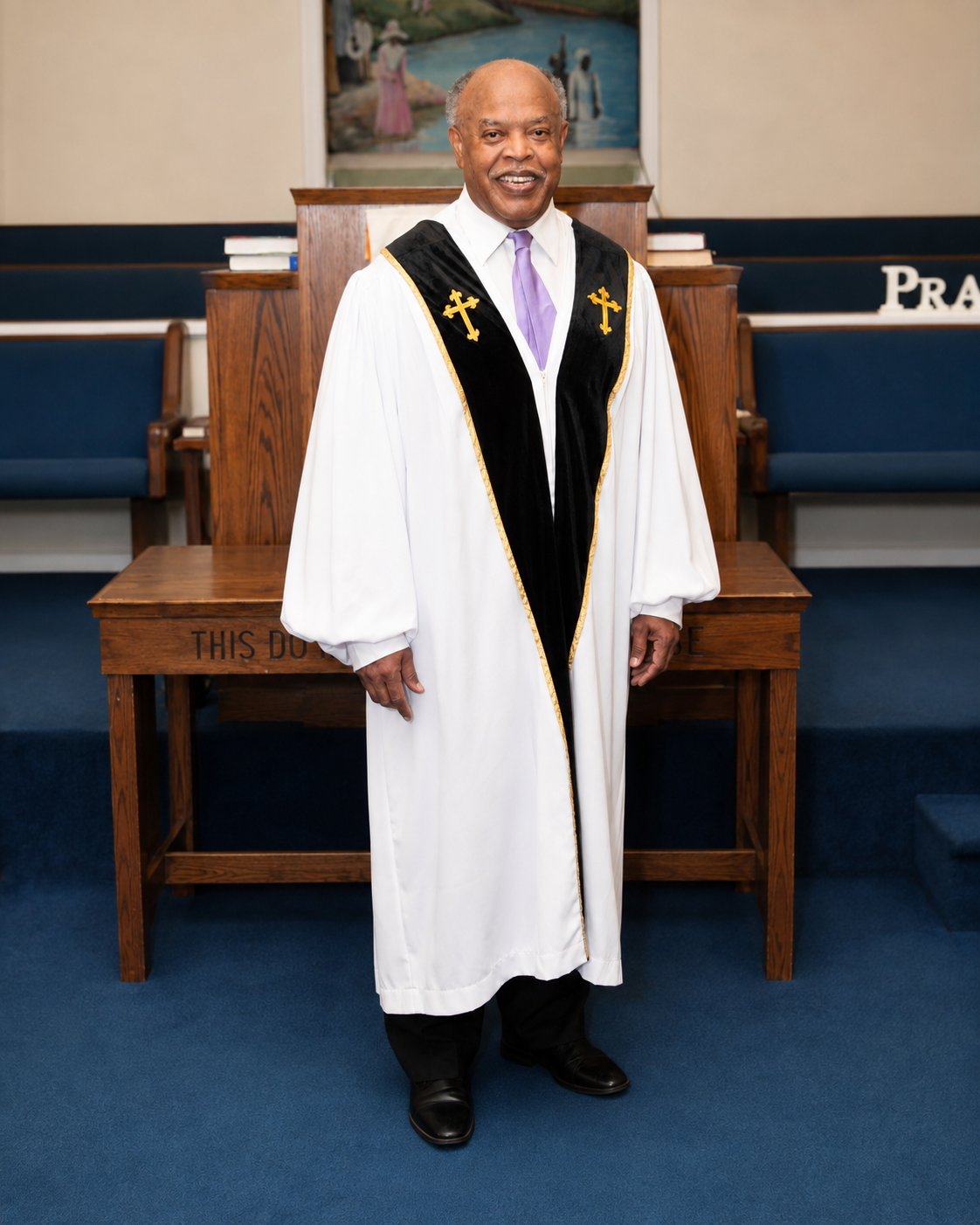 Reverend David Simmons standing at the pulpit in ministerial robes